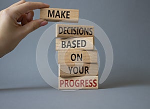 Decision and Progress symbol. Concept words Make decisions based on your progress on wooden blocks. Businessman hand. Beautiful