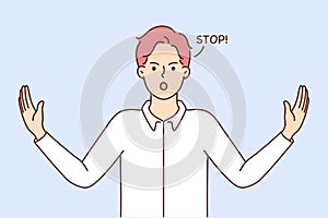 Decisive young man show stop gesture