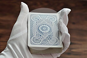 A deck of cards being held in a magicians hand photo