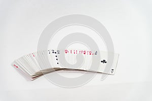 deck of cards of both colors face up on white table