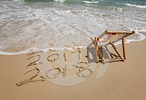 Deck chair with 2018 and 2017 inscription written in sand
