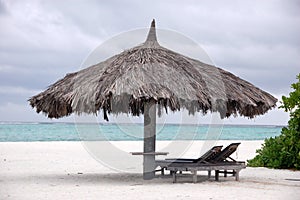 Deck chair and big umbrella at beach