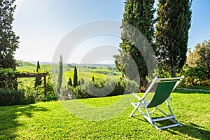 Deck chair on the green meadow