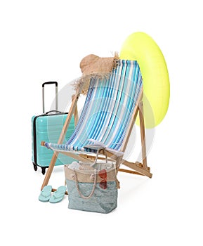 Deck chair, inflatable ring, suitcase and beach accessories isolated on white