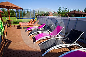 Deck chairs ar backyard swimming pool
