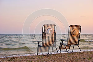 Deck chairs on a beach.