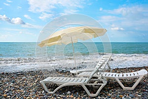 Deck-chairs and beach umbrella, ashore sea. travel background. beach chair on the beach