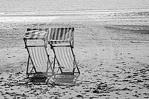 Deck chairs on a deserted beach