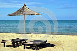 Deck chairs and umbrella on a sandy beach