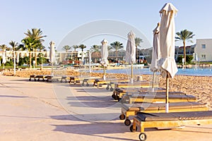 Deck chairs with umbrellas by the pool