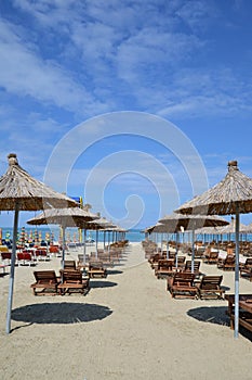 Deck chairs and umbrellas on a sandy beach