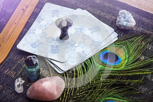 Deck with divination homemade Angel cards on black table, surrounded with semi precious stones crystals.