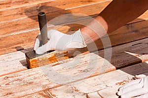 Deck maintenance apply stain on wooden decking