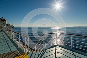 Deck of Mediterranean ferry heading towards the sun