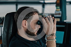 Deck navigation officer on the navigation bridge. He looks through binoculars