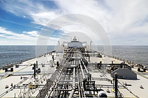 Deck of new oil tanker in the sea under sky.