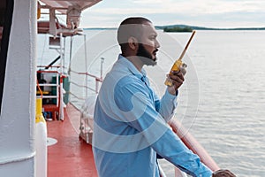 Deck officer on the deck of a ship or offshore vessel. You have in your hands a VHF walkie-talkie radio