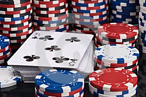 Deck of playing cards surrounded by stacks of poker chips background