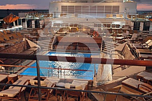 Deck with pool on cruise liner at sunset