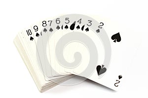 A deck of regular poker cards against a white backdrop