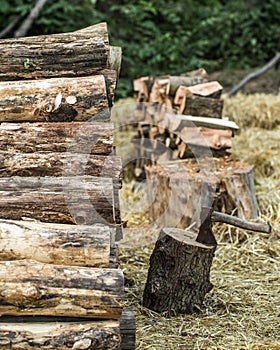 A deck of stacked logs and an axe
