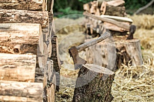 A deck of stacked logs and an axe