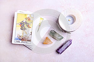 A deck of tarot cards and mineral stones