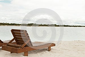 Deckchair lounger on the edge of the beach in summer with nice tropical weather