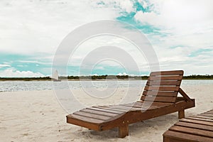 Deckchair lounger on the edge of the beach in summer with nice tropical weather