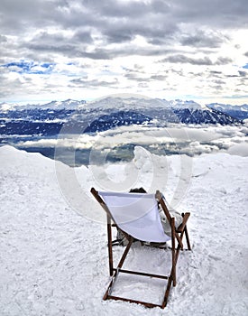Deckchair on the mountaintop in winter snow panorama - Innsbruck - nordkette peak - Austria