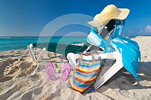 Deckchair with sun accessories on the Caribbean be