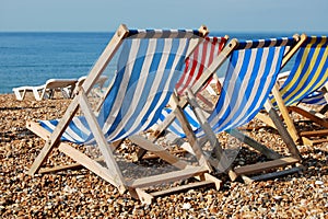 Deckchairs on a pebble beach photo