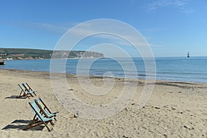 Deckchairs and view over bay from Swanage beach