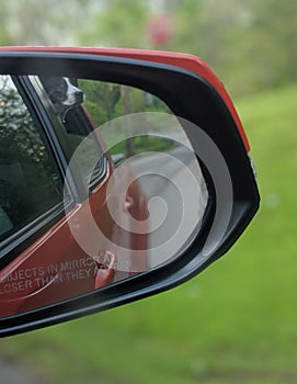 Decker rat terrier dog looking out window and can see inside  truck mirror