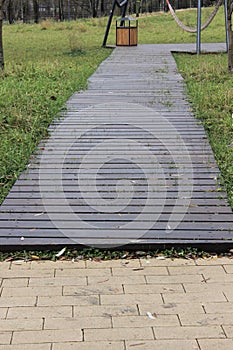 Decking made of wooden planks on the lawn. Moscow. Russia.