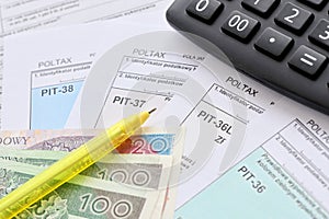Declaration of the amount of earned income or incurred loss, PIT-36, PIT-36L, PIT-37 and PIT-38 tax forms on accountant photo
