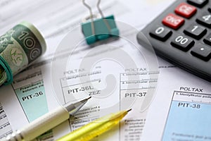 Declaration of the amount of earned income or incurred loss, PIT-36, PIT-36L, PIT-37 and PIT-38 tax forms on accountant photo