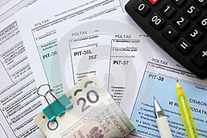 Declaration of the amount of earned income or incurred loss, PIT-36, PIT-36L, PIT-37 and PIT-38 tax forms on accountant photo