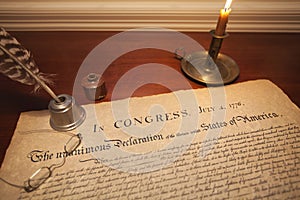 Declaration of Independence with glasses, quill pen and candle photo