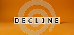 Decline symbol. Concept word Decline on wooden cubes. Beautiful orange background. Business and Decline concept. Copy space