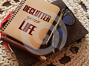 Declutter Your Life on the cover of notebook, glasses, pen. business concept