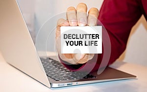 DECLUTTER YOUR LIFE text concept write on a notebook on wooden background