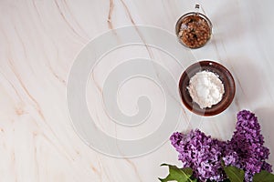 Decoction of lilac flowers Syringa vulgaris and potato starch on a marble background