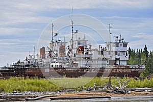 Decommissioned ships, cut and left on the shore photo