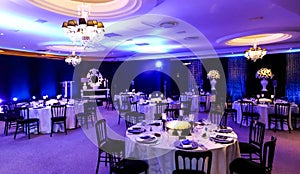 Decor with candles, flowers and lamps for a large corporate party event or Gala Dinner