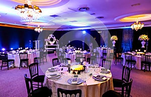 Decor with candles, flowers and lamps for a large corporate party event or Gala Dinner