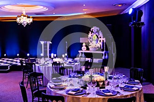 Decor with candles, flowers and lamps for a large corporate party event or Gala Dinner