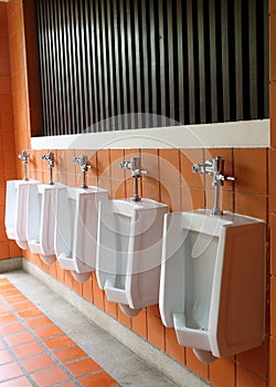 Decor interior of white urinals in men bathroom