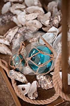 Decor in the maritime theme, anchor, glass bowls, shells, lanterns, ropes.