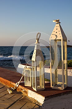 Decor of outdoor cafe with terrace over sea coast. Malia, Crete, Greece.